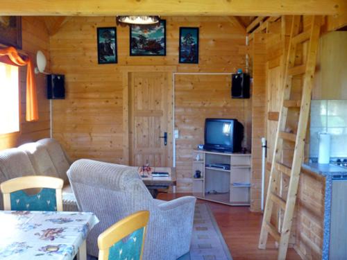 a living room with a couch and a television at Zur Sonne in Freest