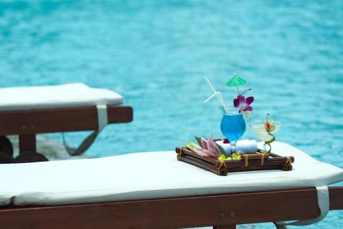a tray with a drink on a table next to the water at Muong Thanh Grand Xa La Hotel in Hanoi