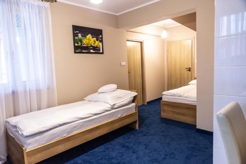 a room with two beds and a window at RR pokoje in Kielce