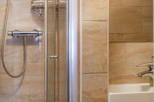 um chuveiro com uma mangueira na casa de banho em TH Serviced Apartment London em Northolt