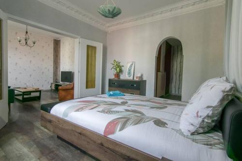 a bedroom with a large bed in a room at auberge du tempo in Riedisheim