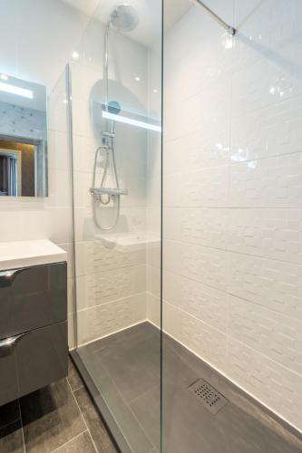 a shower with a glass door in a bathroom at Hôtel - Restaurant Saint Jacques in Blois
