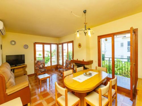 a living room with a wooden table and chairs at Holiday Home Angel Guimera by Interhome in Creixell