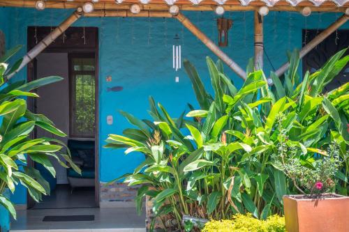 a blue house with plants in front of it at Hotel Campestre Solar De La Luna in Armenia