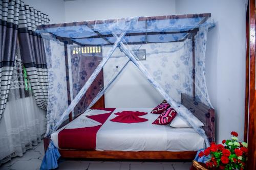 a bed with a canopy in a room at Nehansa Resort and safari in Tissamaharama