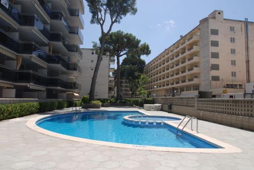 a swimming pool in front of a building at Zeus Montblanc in Salou