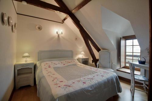 a bedroom with a bed and a table and a window at Anousta in Loubajas