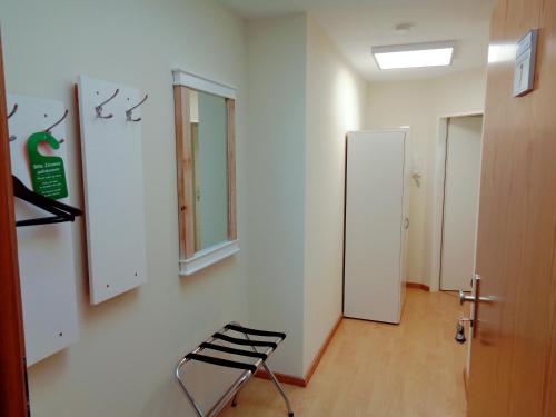a empty room with a chair and a door at Gästehaus Schiemann in Teterow
