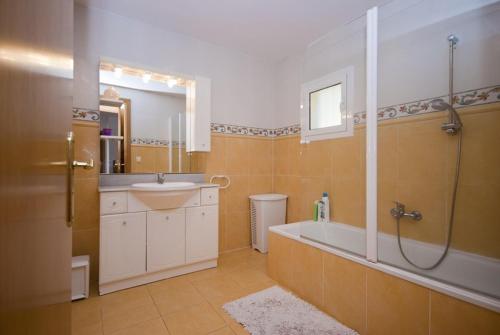 a bathroom with a tub and a sink and a shower at Club Villamar - Claire in Tossa de Mar