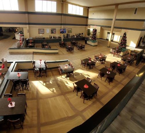 an overhead view of a restaurant with tables and chairs at Ramada by Wyndham North Platte in North Platte