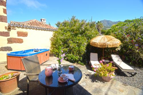 a patio with a table and an umbrella at El Morro in El Paso