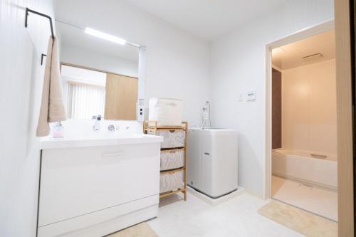 bagno bianco con lavandino e frigorifero di Nakagami-gun - House / Vacation STAY 73991 a Tokeshi