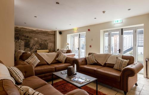a living room with couches and a coffee table at The Pennington Hotel in Ravenglass