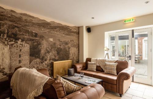 a living room with two couches and a painting on the wall at The Pennington Hotel in Ravenglass