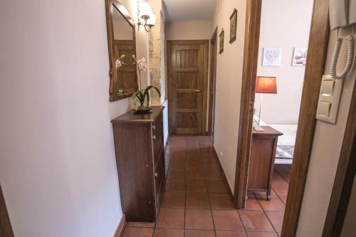 a hallway with a bathroom with a sink and a mirror at Balcones con Encanto - vistas al conjunto monumental Patrimonio de la Humanidad in Úbeda