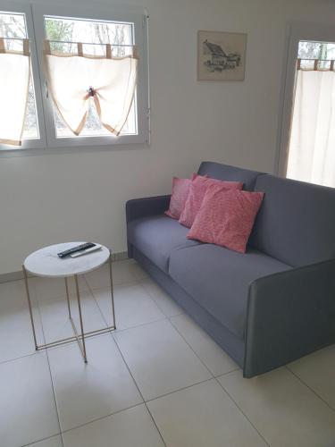 a living room with a couch and a table at Gîte La Broye in Surpierre