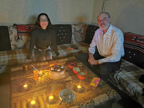 a man and a woman sitting on a couch with lights at Petra View Flat in Wadi Musa