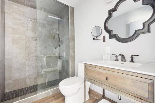 a bathroom with a toilet and a sink and a shower at Sonder The Wellesley in Toronto