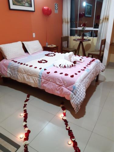 a bedroom with a bed with lights on the floor at Hostal Capac in Ayacucho