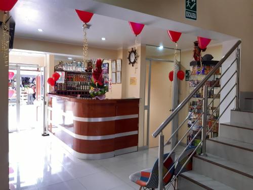 a bar in a store with red balloons hanging from the ceiling at Hostal Capac in Ayacucho