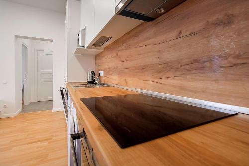 a kitchen with a wooden counter top and a sink at Residential Barona Apartments in Riga Centre in Rīga
