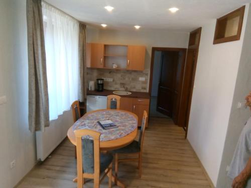 a small room with a table and a kitchen at Appartment 2 in Braşov