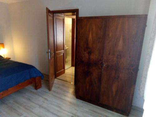 a bedroom with a bed and a wooden closet at Appartment 2 in Braşov