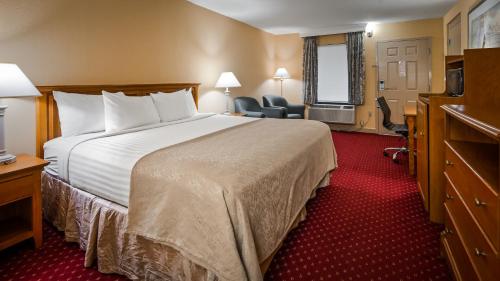 a hotel room with a large bed and a desk at Bryson Inn in Mount Airy