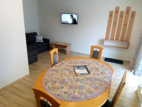 a living room with a table with a laptop on it at Appartment 2 in Braşov