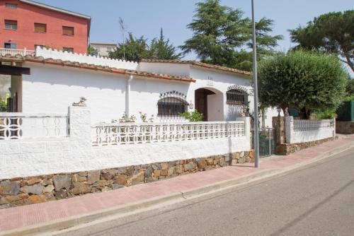 a white house on the side of a street at Club Villamar - Nepal in Calonge