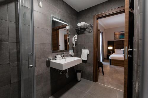 a bathroom with a sink and a mirror at Pebbles Resort in St Paul's Bay