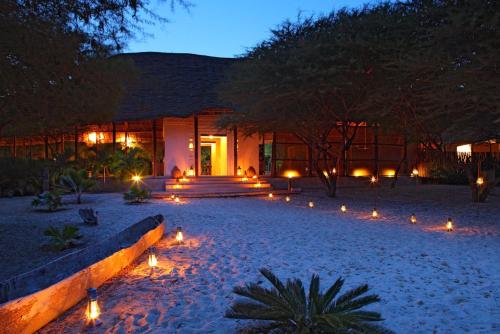 a house with lights in front of it at night at The Red Pepper House in Lamu