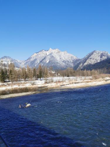 a view of a river with mountains in the background at Zamoček in Matiašovce