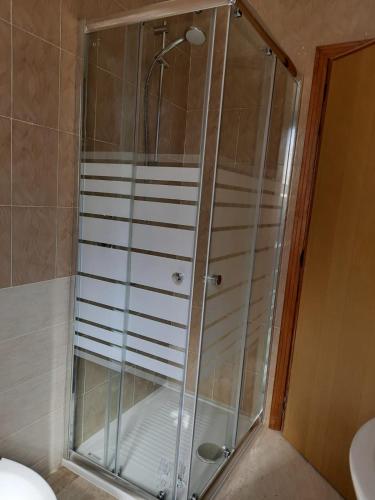 a shower with a glass door in a bathroom at Casa Vacanze Arba Girasole in Girasole