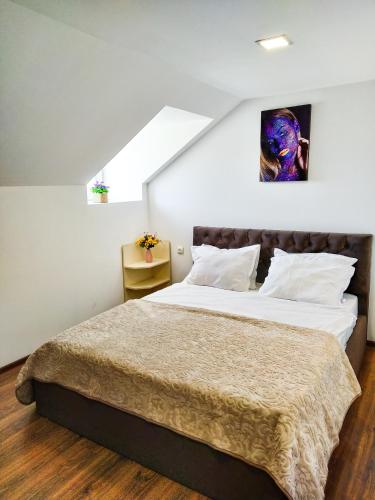 a bedroom with a large bed in a attic at Old Tbilisi Apartments in Tbilisi City