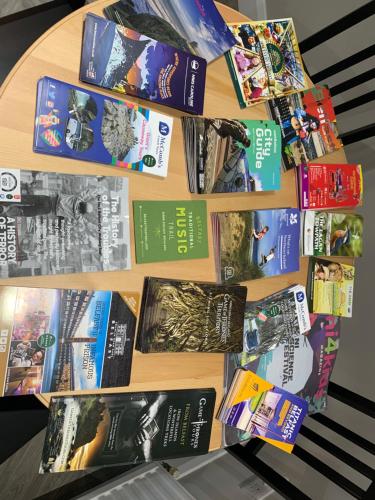 a bunch of books are on a table at Fab City Centre Pad, walking distance to City Centre in Belfast