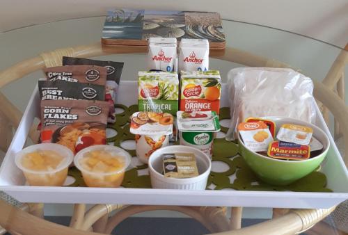 a table with a tray of food and snacks at Pauanui Pines Motor Lodge in Pauanui