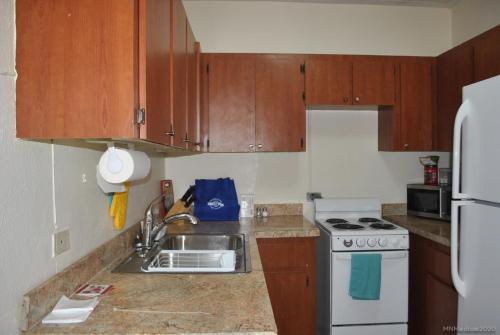 a kitchen with a sink and a stove at Tropical Hideaway in Nassau