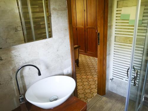 a bathroom with a toilet and a glass shower at Locanda SottoBosco in San Leonardo