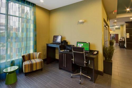 an office with a desk with a computer and a chair at Holiday Inn Christiansburg Blacksburg by IHG in Christiansburg
