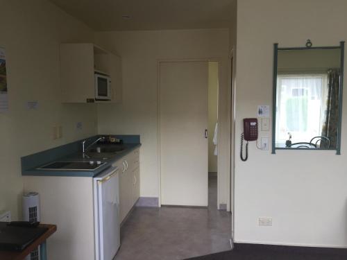 a kitchen with a sink and a counter top at Bentons Motel in Levin