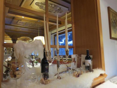 a table with wine bottles and glasses on it at Hotel Sonnblick in Wald am Arlberg