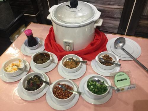 a table with bowls of food and a pot of food at Good Hope Hotel in Skudai