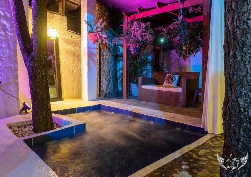 a room with trees and a room with purple lighting at Hotel Infinito La Casona in Villavieja