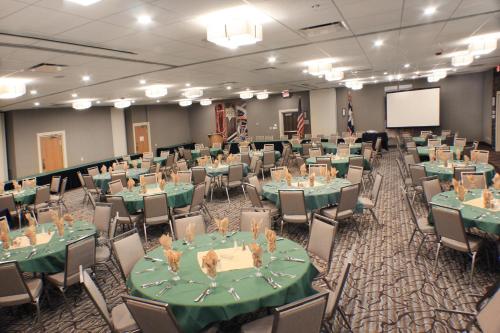 a banquet hall with green tables and chairs at Holiday Inn Cody - Convention Center by IHG in Cody