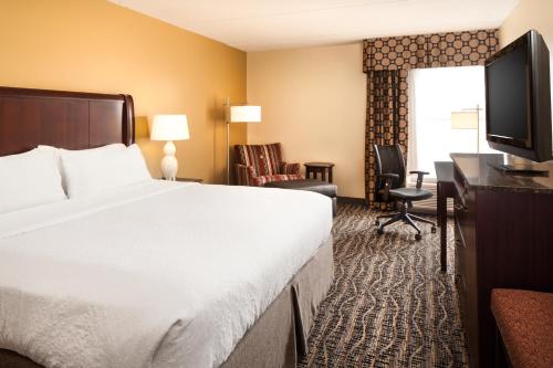 a hotel room with a large bed and a television at Holiday Inn Dubuque/Galena by IHG in Dubuque