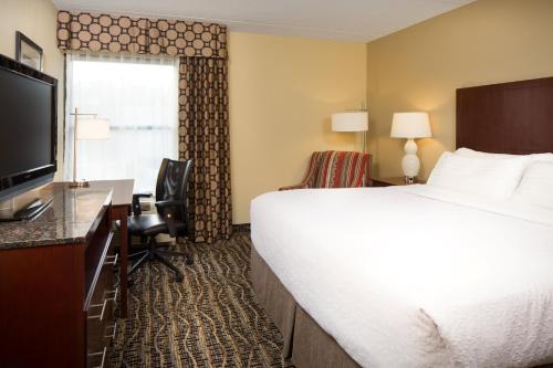 a hotel room with a large bed and a television at Holiday Inn Dubuque/Galena by IHG in Dubuque