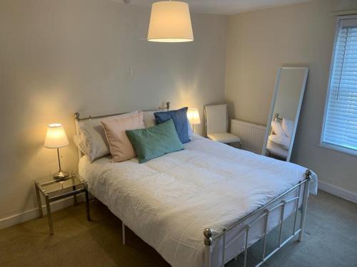 a bedroom with a large bed with pillows on it at The Salisbury Townhouse in Salisbury