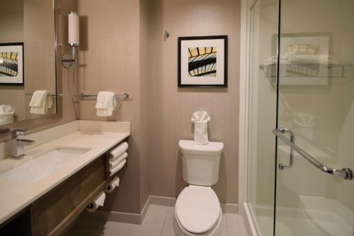 a bathroom with a toilet and a sink and a shower at Holiday Inn Cincinnati North West Chester by IHG in West Chester