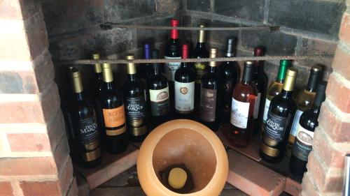 a bunch of wine bottles in a wall with a toilet at Pousada Chalé Suíço in Paraty
